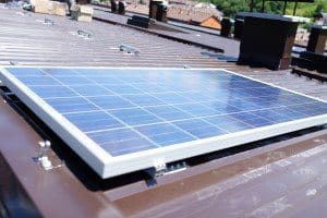 Man installing alternative energy photovoltaic solar panels