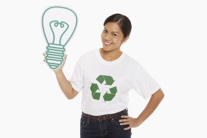 Happy woman holding up a cardboard light bulb