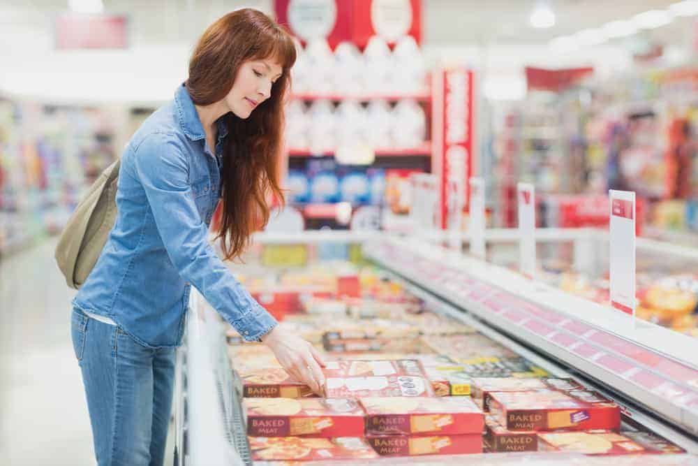 woman looking at frozen food packaging | BPFY